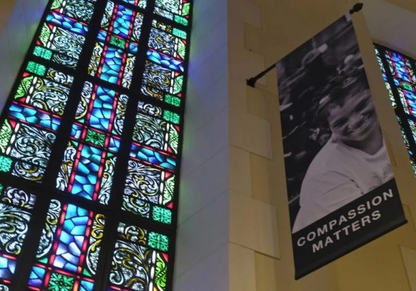 stained glass and compassion banner