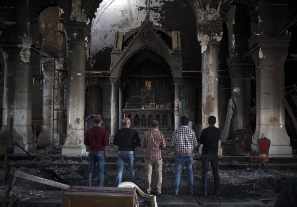 Iraqi Christians pray at church damaged by ISIS fighters