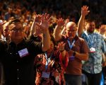 lifting hands in prayer at SBC annual meeting
