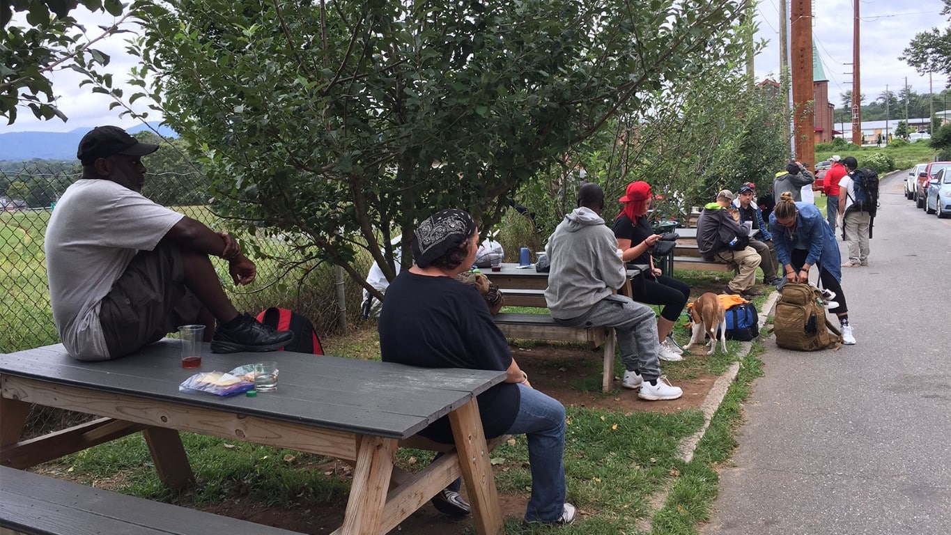 city’s poor congregate around picnic tables