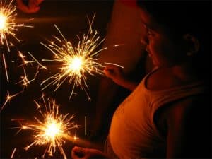 Hindu boy holds sparklers