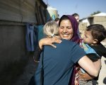 A female Syrian refugee hugs