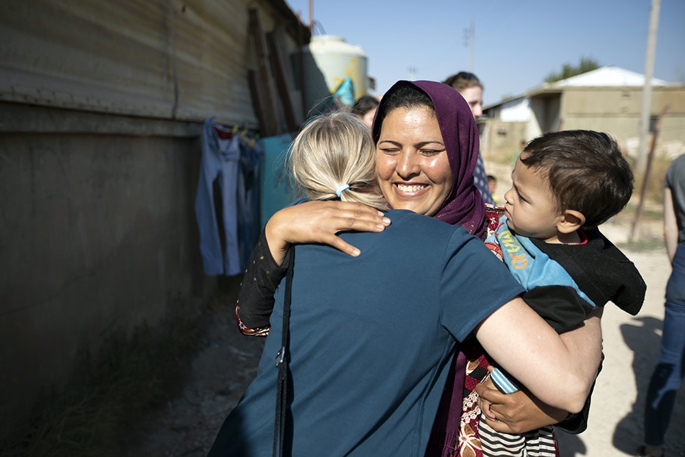 A female Syrian refugee hugs