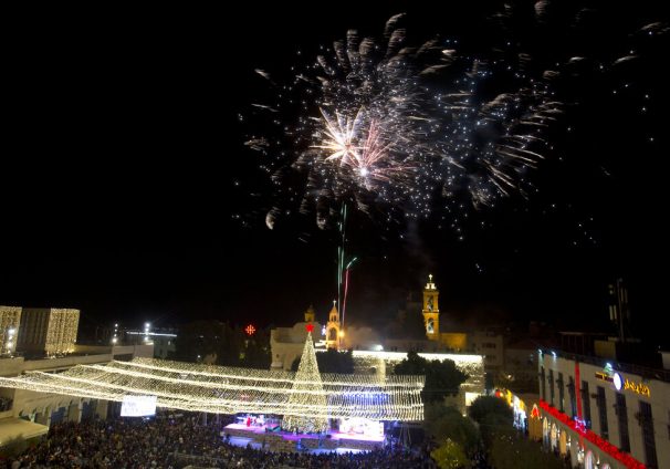 Palestinian Christians celebrate the lighting of a Christmas tree