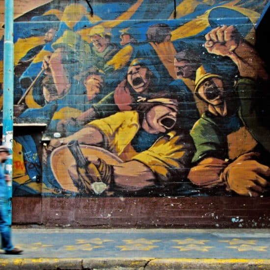 man walking by graffiti
