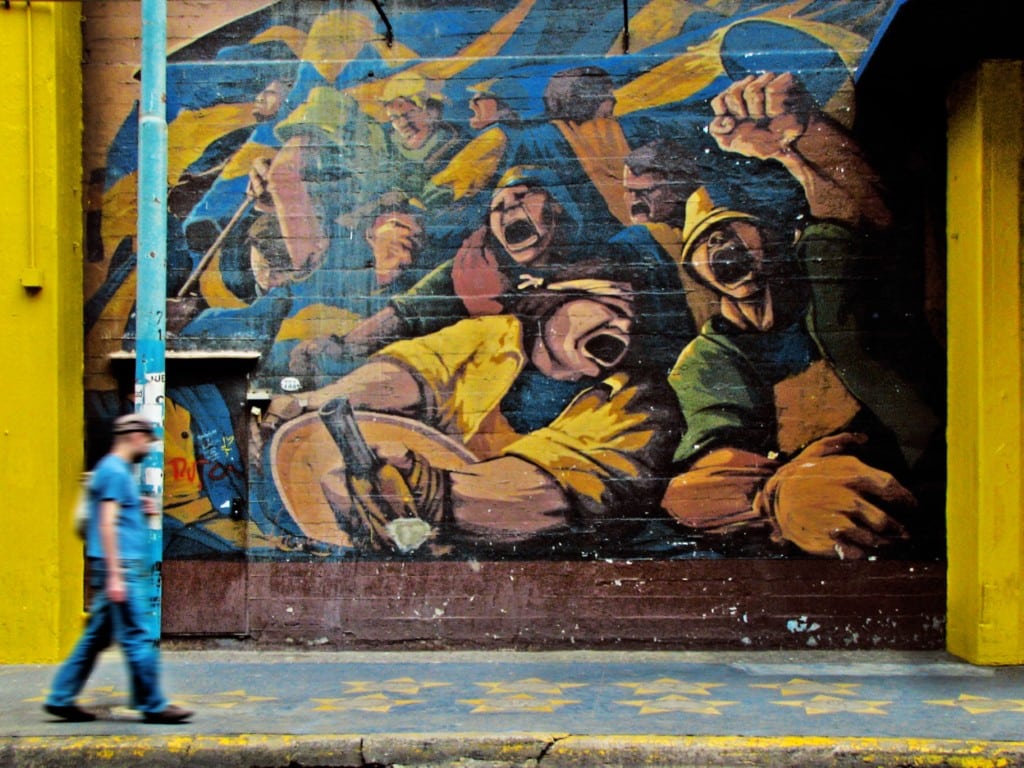 man walking by graffiti