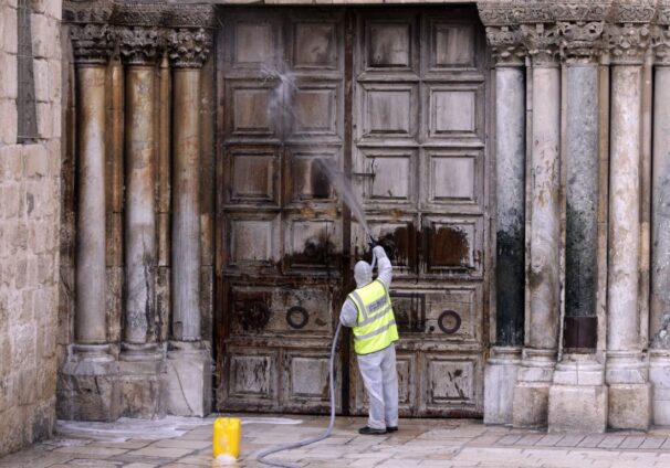 worker disinfects the doors