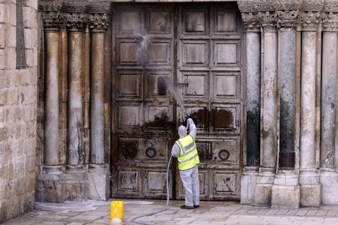 worker disinfects the doors