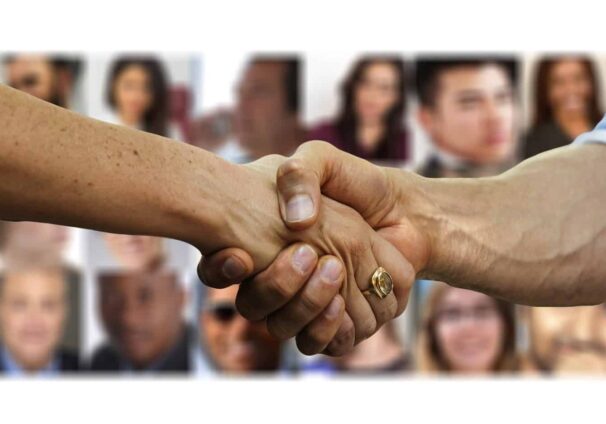 shaking hands over faces