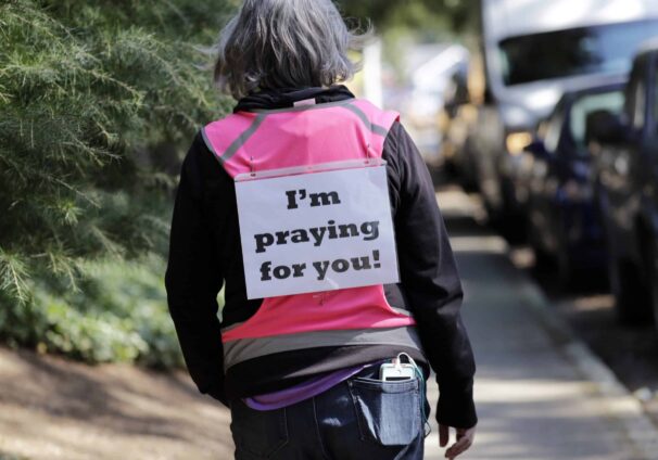 Lois Casimes wears a sign