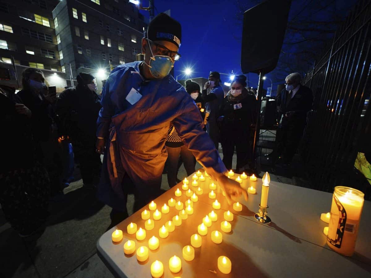 Health service workers light candles