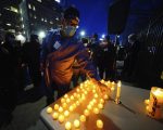 Health service workers light candles
