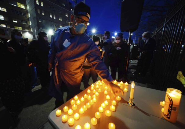 Health service workers light candles