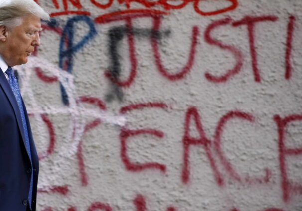 Donald Trump in front of graffiti