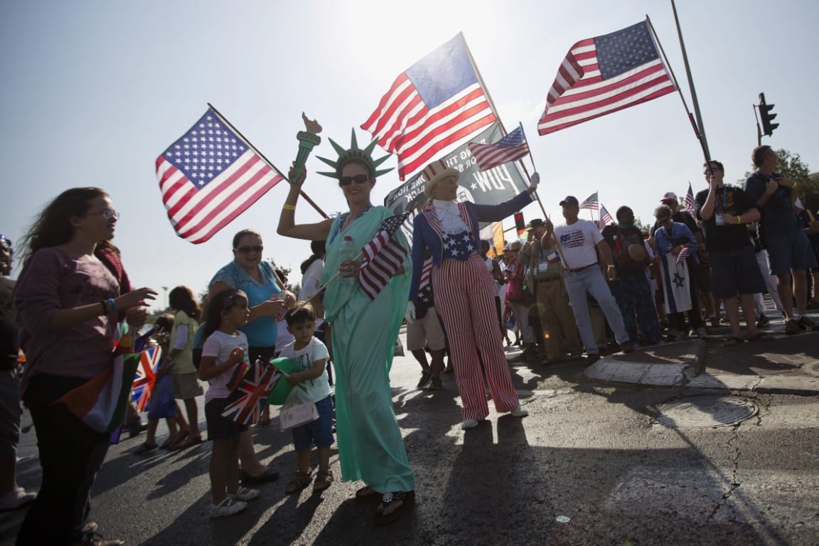 evangelical Christians from various countries wave American flags