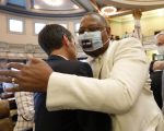 Sen. Briggs Hopson, left, R-Vicksburg, is hugged by Sen. Robert Jackson, D-Marks