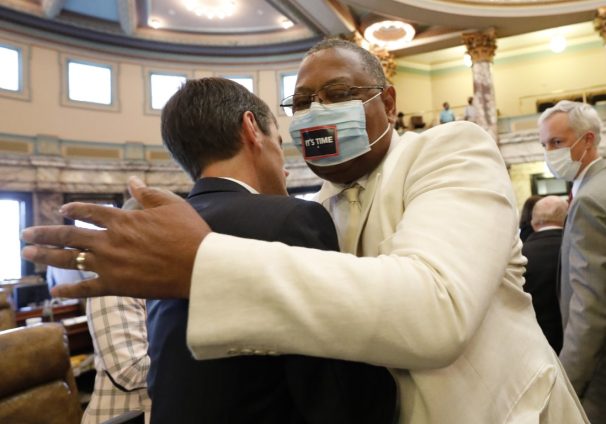 Sen. Briggs Hopson, left, R-Vicksburg, is hugged by Sen. Robert Jackson, D-Marks