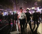 Police advance to arrest protesters breaking curfew