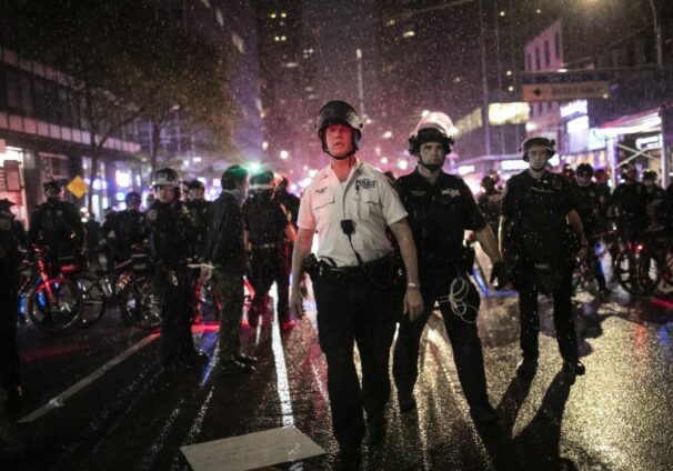 Police advance to arrest protesters breaking curfew