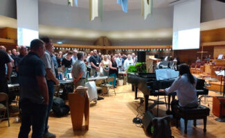 Delegates sing during the Christian Reformed Church annual synod at Calvin University in Grand Rapids, Michigan. (Photo by Ethan Meyers)